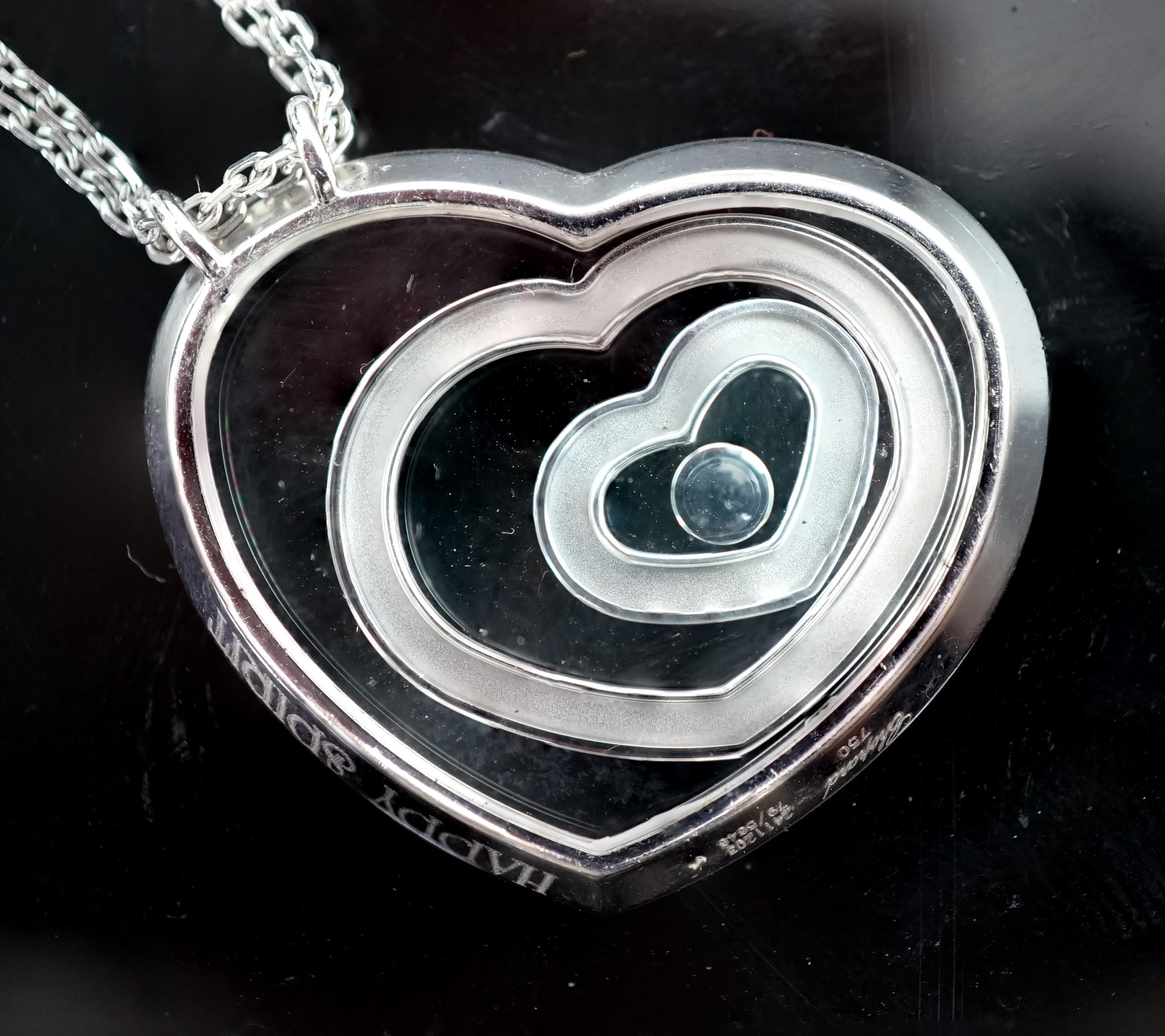 A modern Chopard 18ct white gold and diamond set 'Happy Spirit' heart shape pendant, on a Chopard 18ct white gold double strand fine link chain